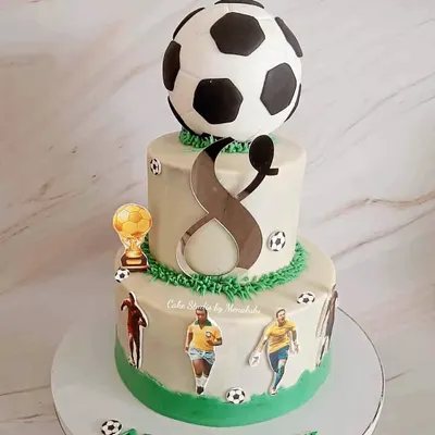 I love this stunning two-tier football themed cake, made with zero fondant. It's perfect for a big celebration, featuring a giant football topper and famous players.
