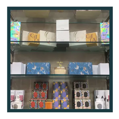 I offer over 30 varieties of beautiful, premium scented candles at my studio. This shelf displays just a fraction of the collection available to add a sensory touch to your hamper.