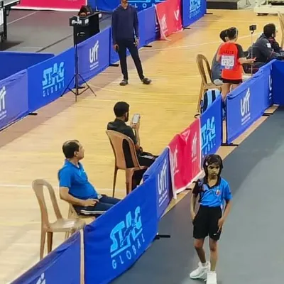 Coaching extends beyond the training hall. Here I am watching our player Ghanavi during a crucial match, providing strategic guidance from the sidelines.