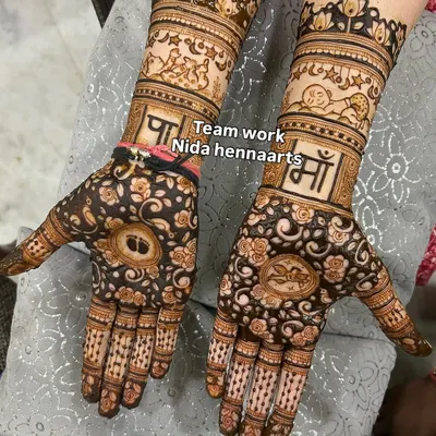 This is a complete godh bharai mehandi design done by my talented team. It includes baby footprints, the words "Paa" and "Maa" (Father and Mother), and other cute baby related motifs.