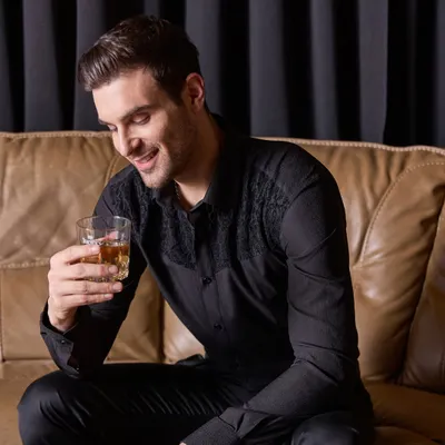 This is my idea of a perfect party shirt. A classic black shirt elevated with subtle, tonal lace embroidery on the shoulders. It's the right combination of fashion, glitz, and understated elegance.