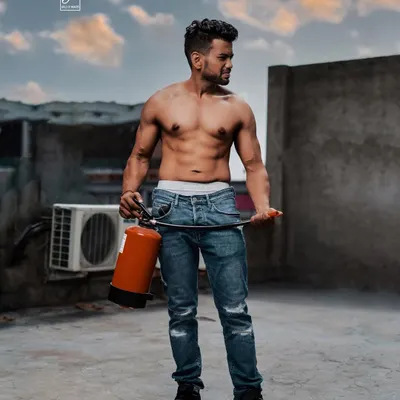 An uncoventional prop for an unconventional setting. This rooftop shoot in Gurgaon uses a fire extinguisher to create a unique, edgy fitness image with an urban, industrial backdrop.
