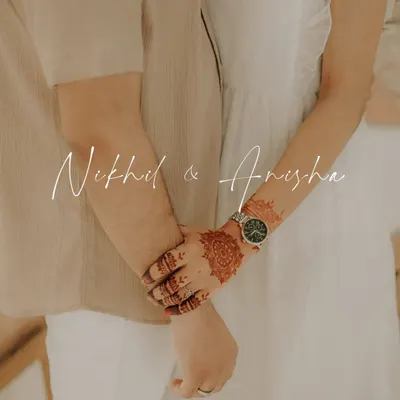 A simple and romantic pre wedding shot, focusing on the couple holding hands. The bride's mehndi adds a touch of tradition to this modern, poetic frame.