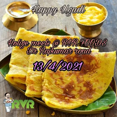 A plate of our warm, freshly made Bele Holige, also known as obbattu. This sweet flatbread is a staple during festivals like Ugadi, and we prepare it with a generous filling and a touch of ghee.