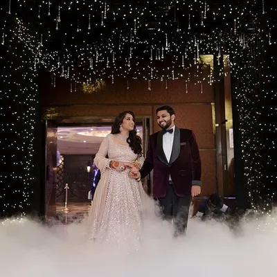 A grand entrance for a grand night. I designed this starlit tunnel with low-lying fog for the couple's Sangeet entry at the Taj Palace, creating a moment of pure cinematic magic.