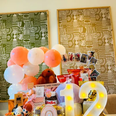 A dreamy peach-themed hamper for a 12th birthday. We included a light-up number '12', a personalized nameplate for Tanishka, and a collection of her favorite things, from Nutella to cute figurines.