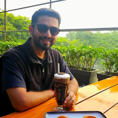 Taking a break at a cafe in Kolhapur. I enjoy exploring new places and food, and this relaxed photo captures a moment of simple enjoyment.