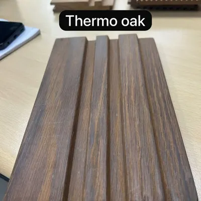 A sample of our innovative solid wood ceiling planks in Thermo Oak. This thermally modified wood offers enhanced durability and a rich, deep color, perfect for premium exterior applications.