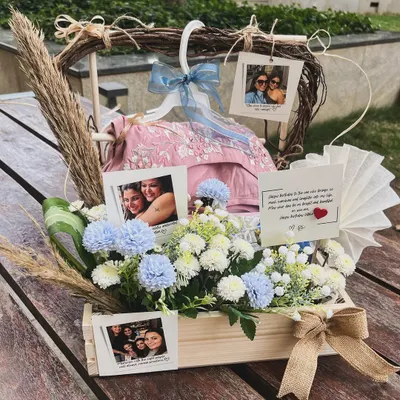 A chic hamper celebrating a special friendship for a birthday. I used a palette of white and powder blue florals to complement the beautiful outfits gifted inside, adding personal photos to truly capture their bond.