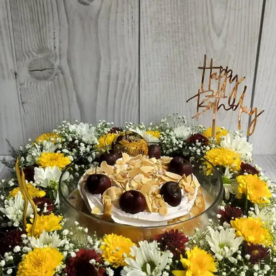 This Cherry Almond Tres Leches Floral Hamper is a perfect birthday centerpiece. The moist cake is topped with cherry whipped cream and toasted almonds, then surrounded by a beautiful arrangement of fresh flowers.