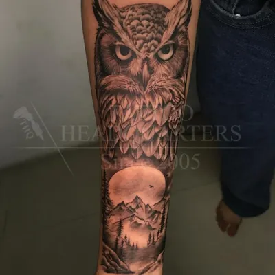 A stunning forearm sleeve featuring a realistic owl against a full moon and a forest landscape. A complete nature scene in one piece.