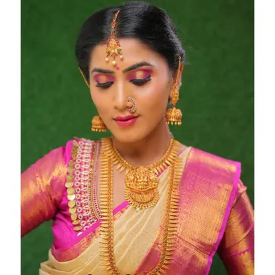 A key part of your final project is a professional photoshoot. This image, part of a student's portfolio, highlights a complete bridal look with a focus on dramatic eye makeup and traditional temple jewelry.