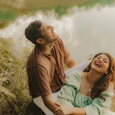 A moment of pure, unscripted laughter by the lake. For us, a pre-wedding shoot in nature is about capturing the joy and freedom you feel when you're together in the wild.