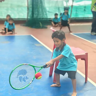 It all starts here. A young player in our Mini-Tennis program learns the fundamentals of a forehand, focusing on making clean contact with the ball. We make learning fun and effective from the very first swing.