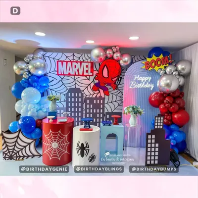 A spectacular Marvel and Spider-Man themed party, featuring a city skyline backdrop, comic book web patterns, and bold red and blue balloon garlands.