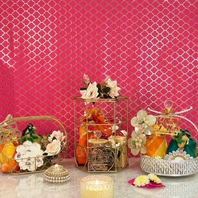 I love creating a sense of abundance and celebration. This photo showcases three of my signature hamper styles: the golden basket, the regal cage, and the silver crystal-top basket, each curated to feel luxurious and special.