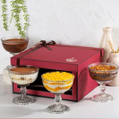 My four-dessert gift box is designed for sharing. It features a curated selection of my Classic Tiramisu, Dark Chocolate Mousse, Mango Cream Cheese Trifle, and Chocolate & Salted Caramel Trifle.