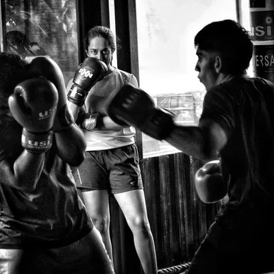 This black and white shot captures the serious, focused environment of our club. Every member is invested in the training.