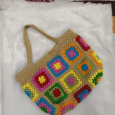 A full view of the vibrant granny square tote bag. Each square is crocheted and joined by hand to create this classic, eye-catching pattern.