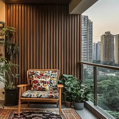 A cozy balcony corner with a comfortable armchair and lush green plants. The vertical wood fluting on the wall adds warmth and texture, creating a perfect reading nook with a city view.