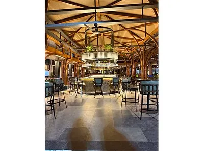 The central bar at the Karnataka Golf Association, featuring a vaulted wooden ceiling and our integrated planting design. The goal was to create a space that feels both grand and intimate, where natural elements complement the architectural vision.