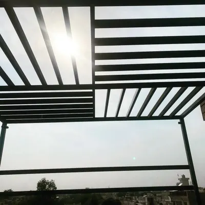 A view from underneath one of our modern MS pergolas. The slatted design creates interesting shadow patterns while providing partial shade from the sun.