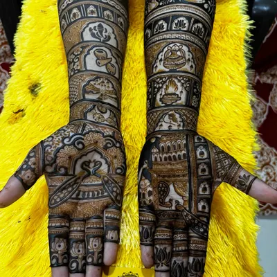 This is a classic full bridal mehndi design created by my team. It features traditional Indian motifs, including palace windows (jharokhas), floral patterns, and paisleys, for a timeless look.