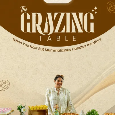 This is what we mean by hassle-free hosting. I'm pictured here with one of our complete grazing table setups, featuring a variety of desserts, snacks, and drinks, all styled and ready for guests.