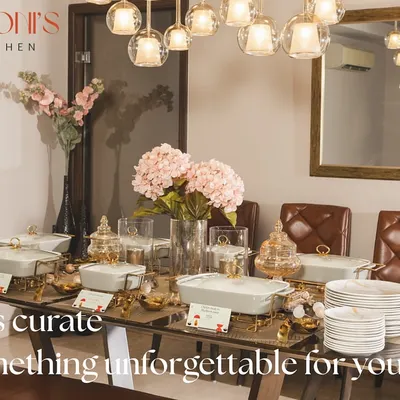 This is an elegant buffet setup in a client's home for a Diwali celebration. I used my signature white and gold serving dishes, complemented by pink hydrangeas and warm lighting to create a sophisticated and welcoming ambiance.