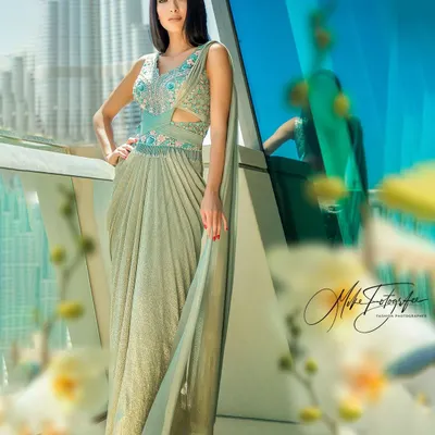 Balancing a high-fashion garment with the iconic Dubai skyline, this shot creates a powerful, aspirational mood. The reflection in the glass adds another layer of visual interest to this luxury campaign image.