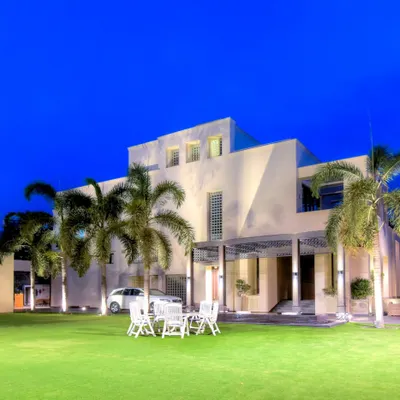 A view of a large residential property where the expansive, perfectly manicured lawn becomes the centerpiece. This space is designed for both large gatherings and quiet enjoyment, framed by mature trees and a modern home exterior.