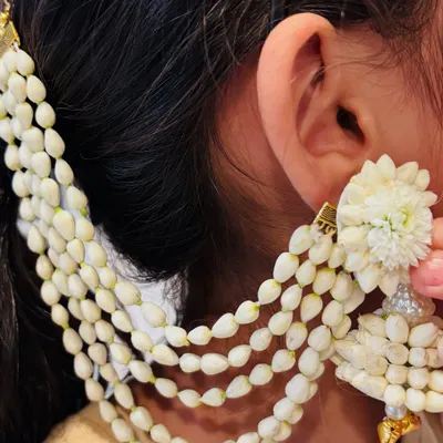 A close-up of a beautiful multi-layered hair accessory, made with mogra buds and pearls. This is a modern take on the traditional gajra.