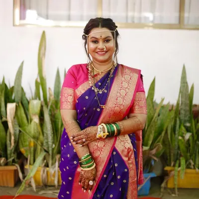A full portrait of my beautiful Marathi bride in her purple navvari saree. The subtle makeup and natural glow perfectly complement her traditional attire for the wedding ceremony.