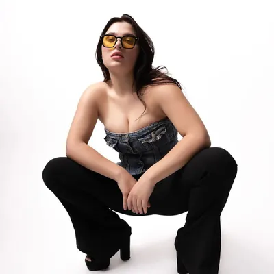 A full-body studio shot of a model in a denim top and bell-bottoms. This image showcases my use of clean, high-key lighting for a modern and edgy fashion look.