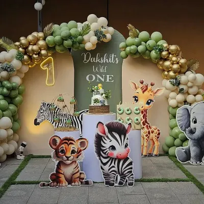 A perfect photo backdrop for a "Wild One" first birthday party. I use a combination of themed cutouts like baby lions and elephants, a full balloon arch, and personalized signage to create an immersive and picture-perfect jungle theme.