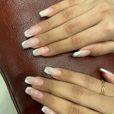 A perfect example of a modern French manicure. This design uses clean, geometric white lines on a natural pink base for a fresh and stylish look.