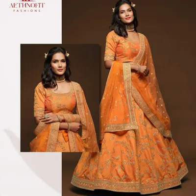 A close-up of the beautiful golden embroidery on my orange silk lehenga. I love how the threadwork catches the light, adding a touch of royalty.