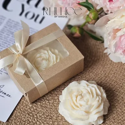 Where elegance meets fragrance. My handcrafted peony candle is delicately shaped to resemble a blooming blossom. It comes in a minimal kraft box, making it a perfect wedding return gift.