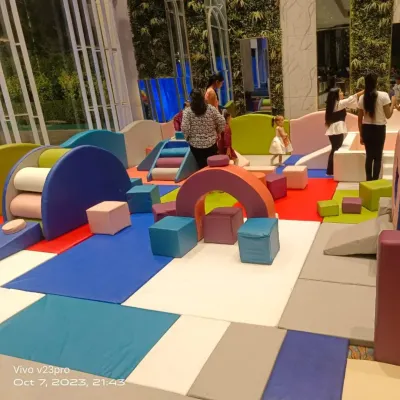 This is a typical indoor soft play zone I set up for a party. It includes a variety of foam blocks, ramps, and climbers on a cushioned mat, creating a safe and stimulating environment for toddlers.