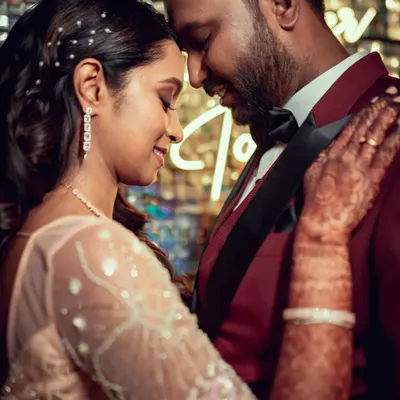 An intimate close-up of a couple dancing at their reception, surrounded by the warm glow of the decor.