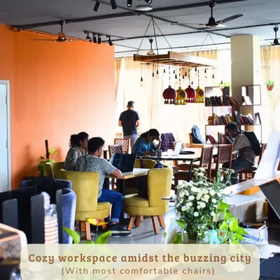This is the heart of my cafe, a cozy workspace buzzing with quiet energy. With comfortable chairs and a warm, inviting atmosphere, it’s the perfect place to settle in and get things done.