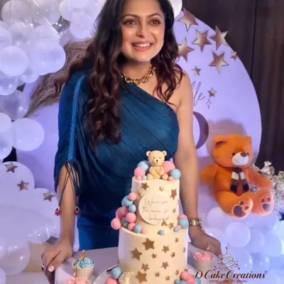 A joyous moment with actress Drashti Dhami at her "Over the Moon" themed baby shower. We designed the two-tier teddy bear cake and matching cupcakes to be the sweet centerpiece of her celebration.