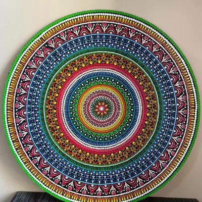 This is a full view of my 24-inch dot mandala, a piece I poured my heart into. Created on a circular MDF board, the intricate patterns and vibrant colors are designed to be a captivating centerpiece for your wall. This artwork is available for purchase.