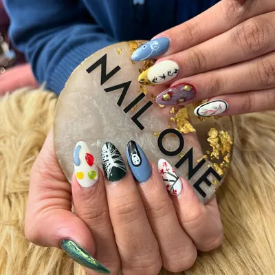 Another angle of our detailed anime-inspired nail art set. This view highlights the different characters and scenes on each nail, showcasing our ability to work with a diverse color palette and intricate line work on a small canvas.