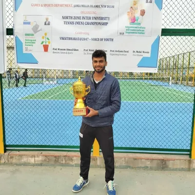 NTC player Udit Kamboj with his winner's trophy after dominating the North Zone Inter-University Men's Singles championship.
