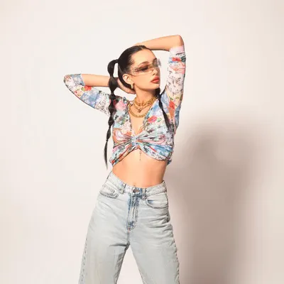 This look is all about channelling a sporty, street-style vibe. I paired a floral crop top with relaxed-fit denim and layered gold chains to create a look that's trendy, confident, and full of personality.