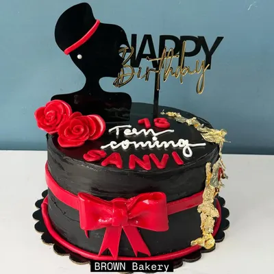 A chic cake for a teenager. This pure chocolate truffle cake features a stylish silhouette topper, a red fondant bow, and a touch of gold leaf for a sophisticated look. We only use fondant for decorations, never for taste.
