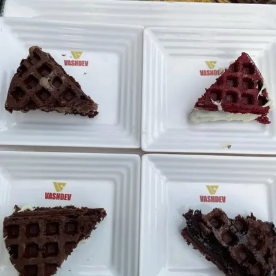 A platter of our assorted live waffles, a crowd-pleaser at any event. This image displays our variety, including classic chocolate, rich dark chocolate, and vibrant red velvet waffles.