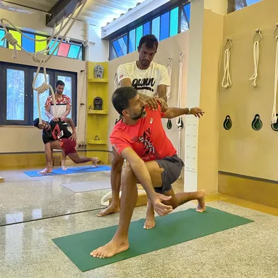 It is always a privilege to collaborate with professional athletes like Rohan Bopanna. Here, we are working on a deep twisting lunge, a pose that is excellent for releasing the hips and spine, crucial for rotational sports like tennis.