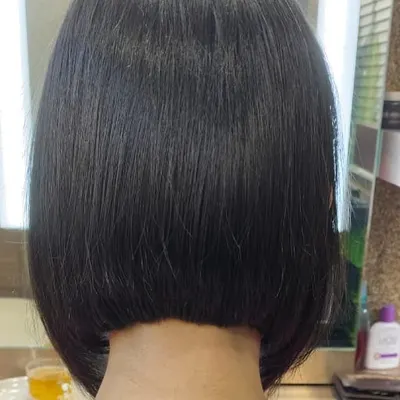 A perfect example of a classic, sharp bob haircut. The precision in the cut creates a clean, strong line, resulting in a timeless and sophisticated style that is effortlessly chic.